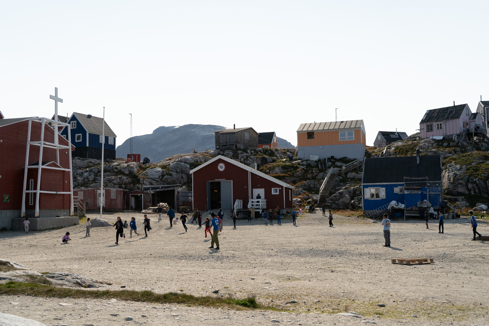Children playing football in the center of the settlement. Photo by Visit East Greenland