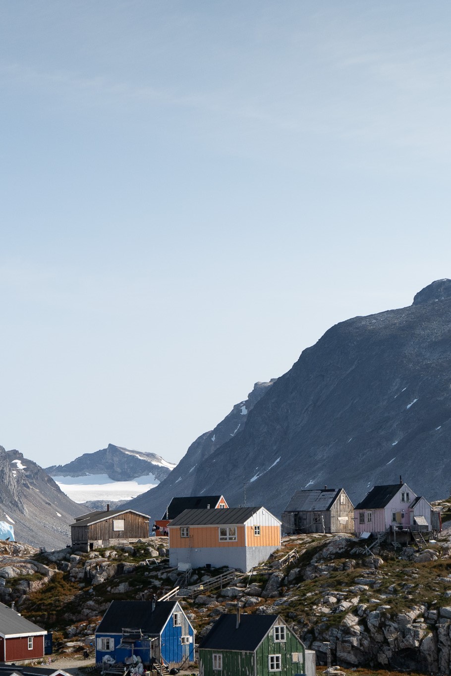 View of houses in Sermiligaaq with the high mountains in the backdrop. Photo by Visit East Greenland