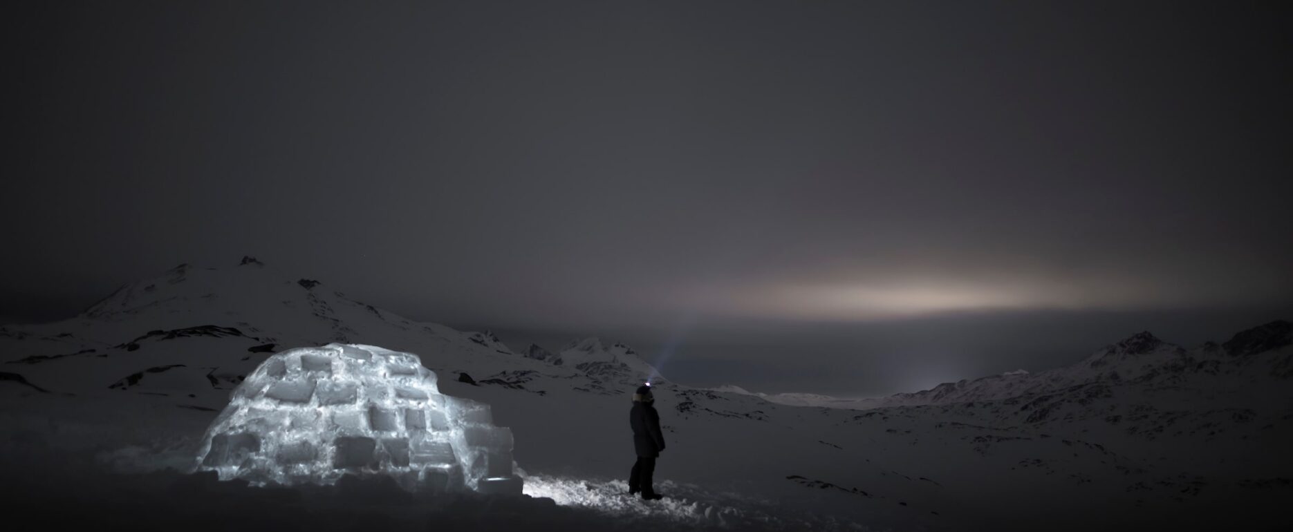 Igloo camping view by the dark night. Photo by Aningaaq Rosing Carlsen - Visit Greenland