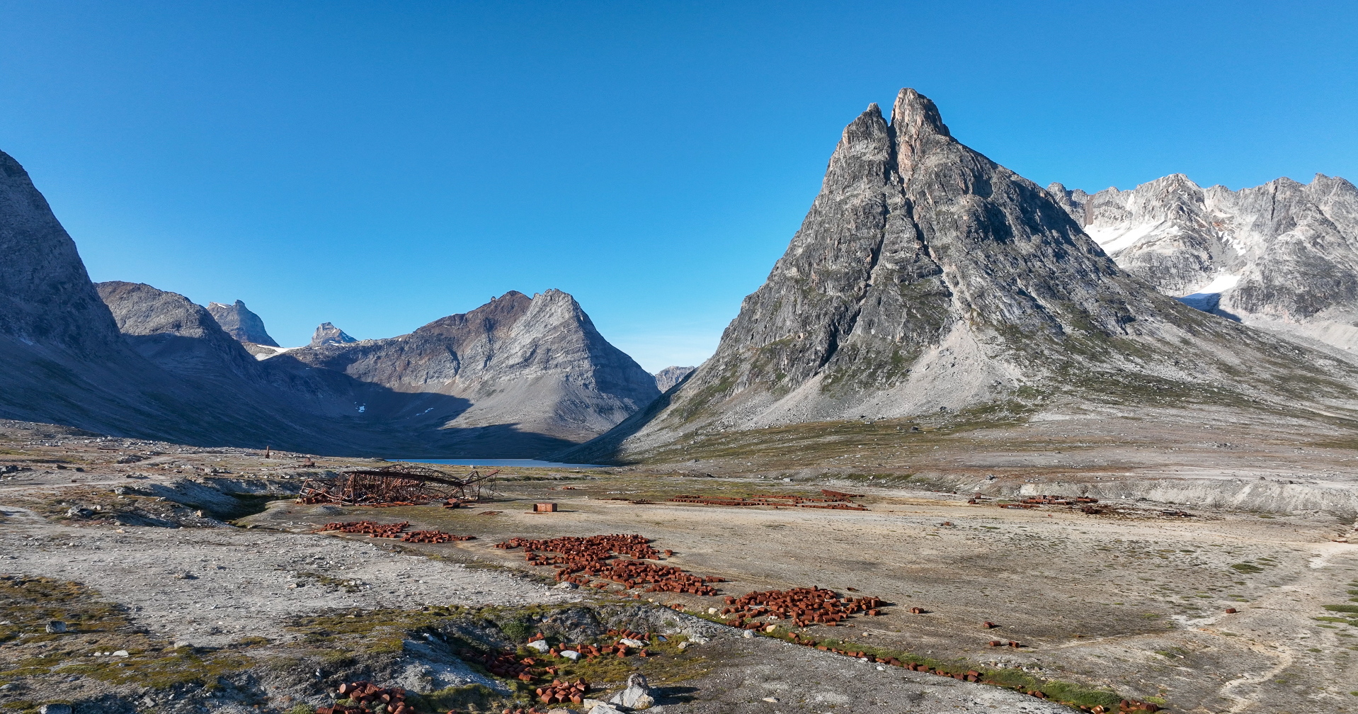 View over Ikateq with mountain views rising behind the flat land. Photo by Anna & Lucas Jahn - Visit East Greenland