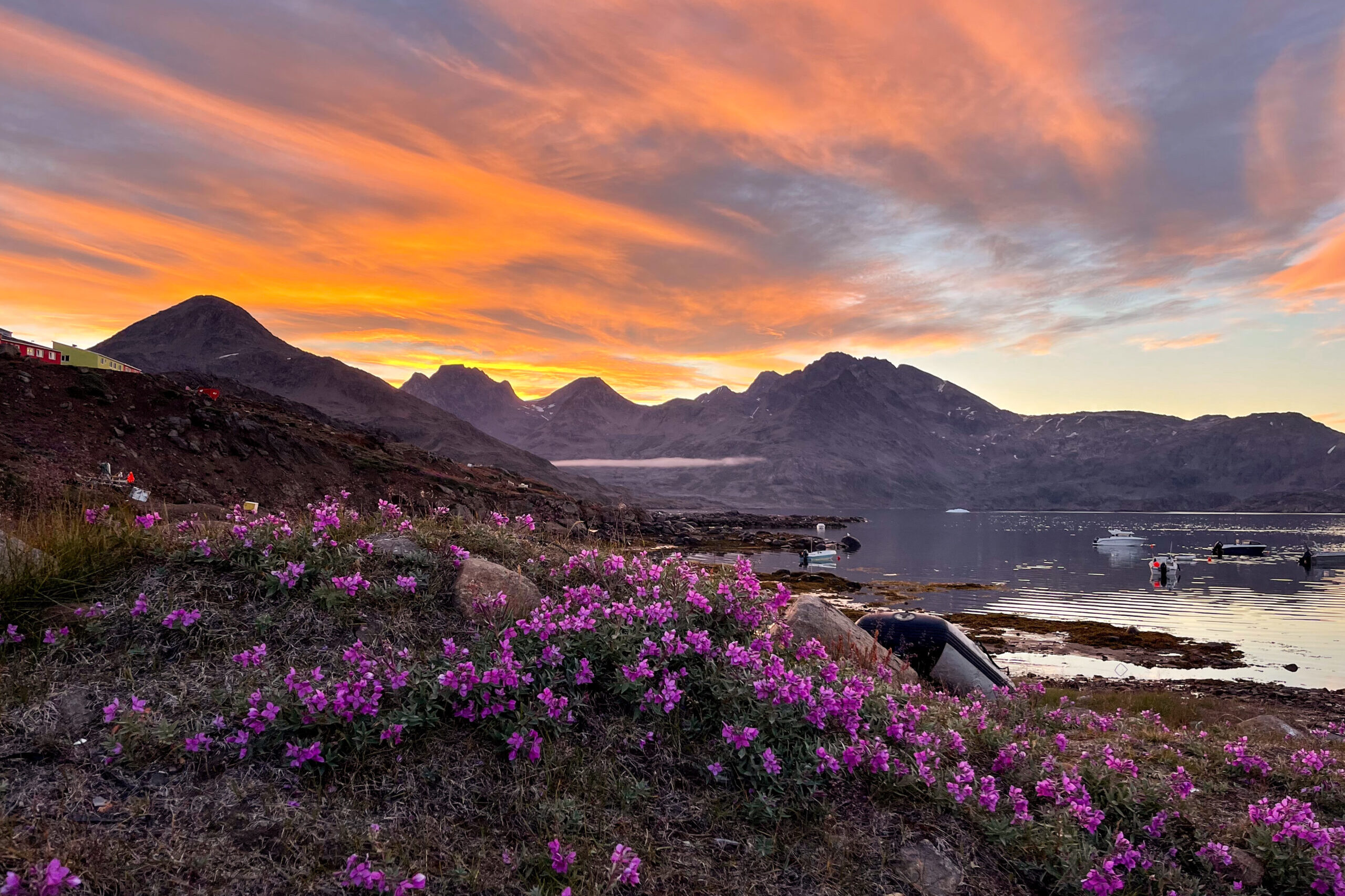 Sunset in Tasiilaq with view over the dog place. Photo by Mathane Qatsa - Visit East Greenland