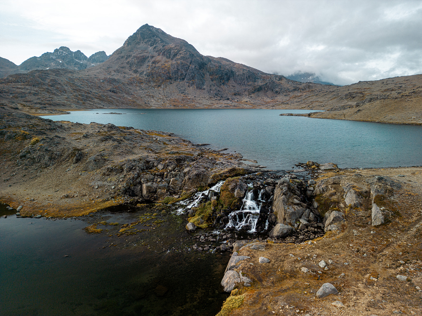 View over the waterfall and lake in the Flower Valley. Photo by Chris Koenig - Visit East Greenland