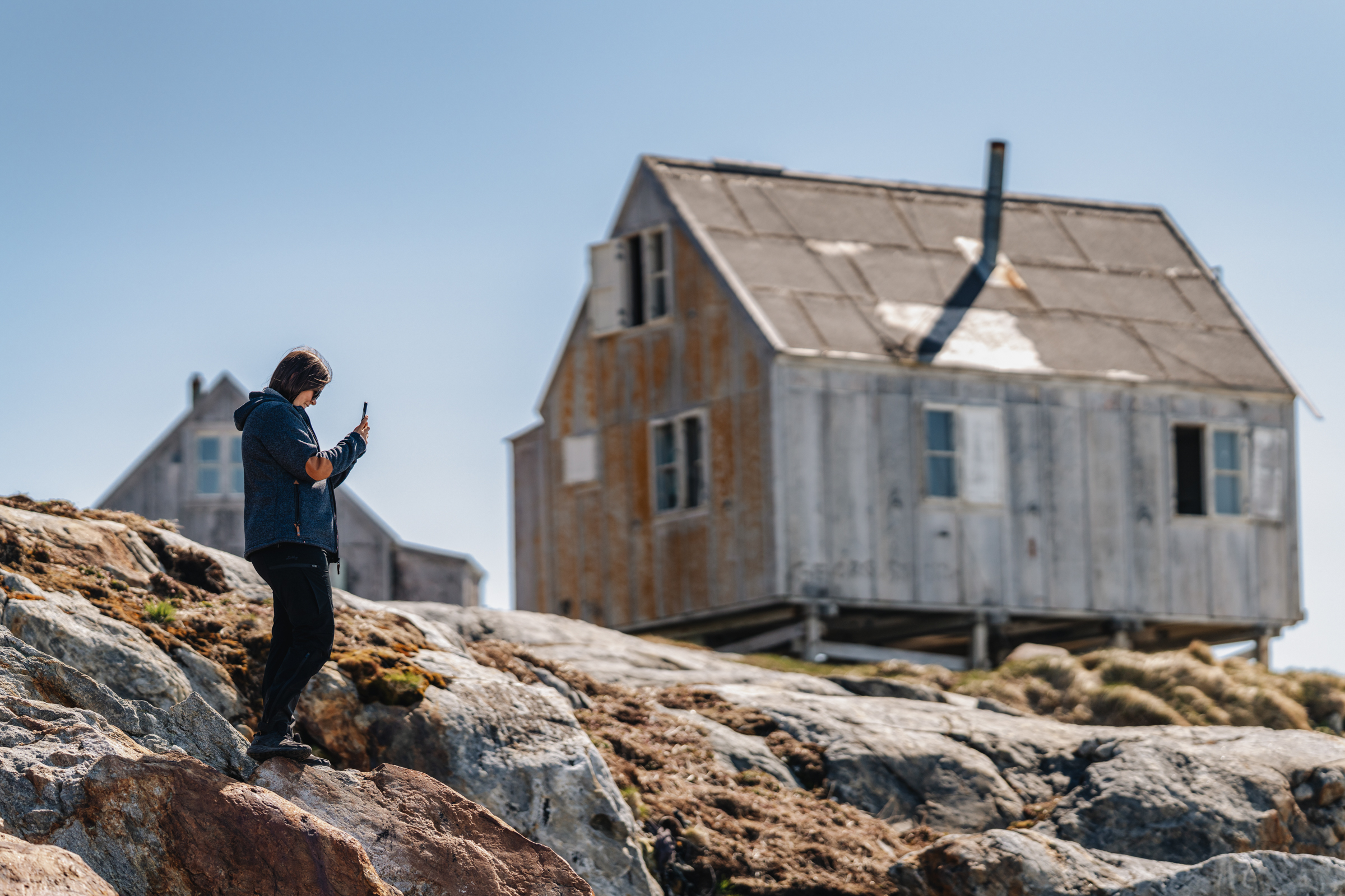 Tourist capturing the moment in Tiilerilaaq. Photo by Filip Gielda - Visit East Greenland