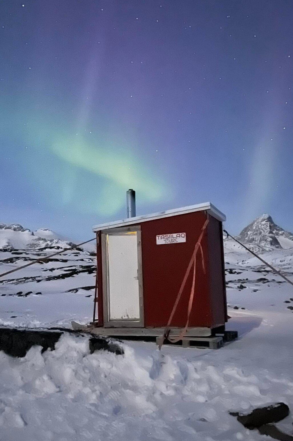 Northern Lights over the sauna. Photo by Tasiilaq Tours