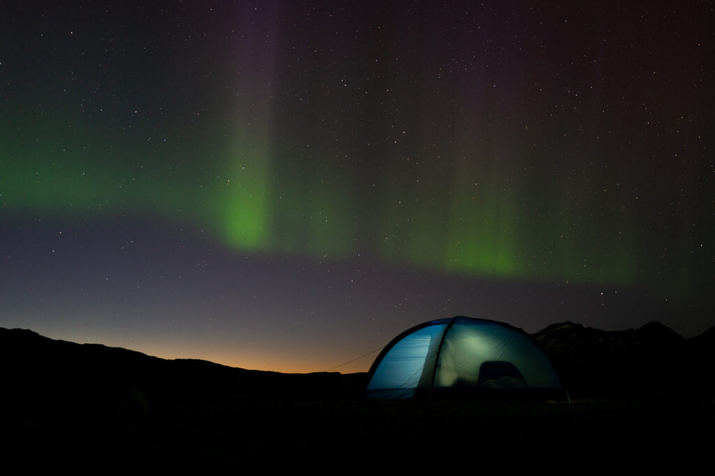 Aurora Borealis at camp in Ammassalik. Photo by Benjamin Story - Visit East Greenland