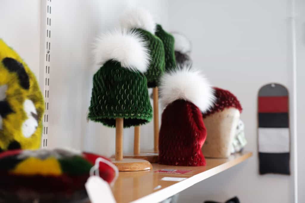 Variety of colorful hats made out of sealskin.